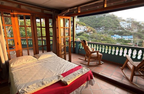 Taganga Hotel | Resort with a pool, ocean view, bar, and restaurant.